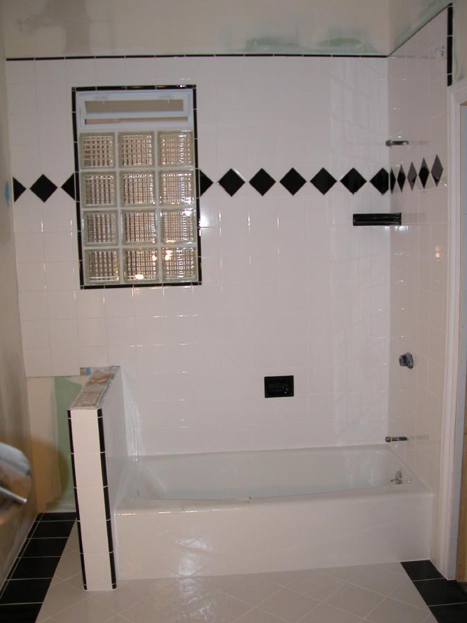 Tub surround, window, trim and floor, ceramic tile.